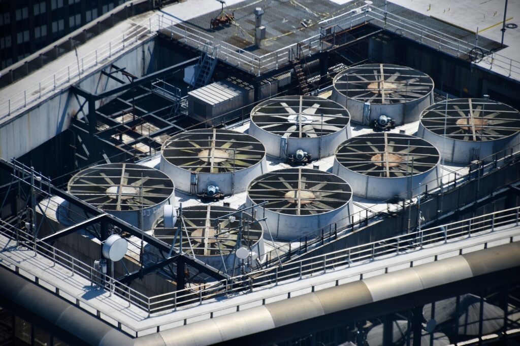 Rooftop mechanical plant with large ventilation fans on a commercial building